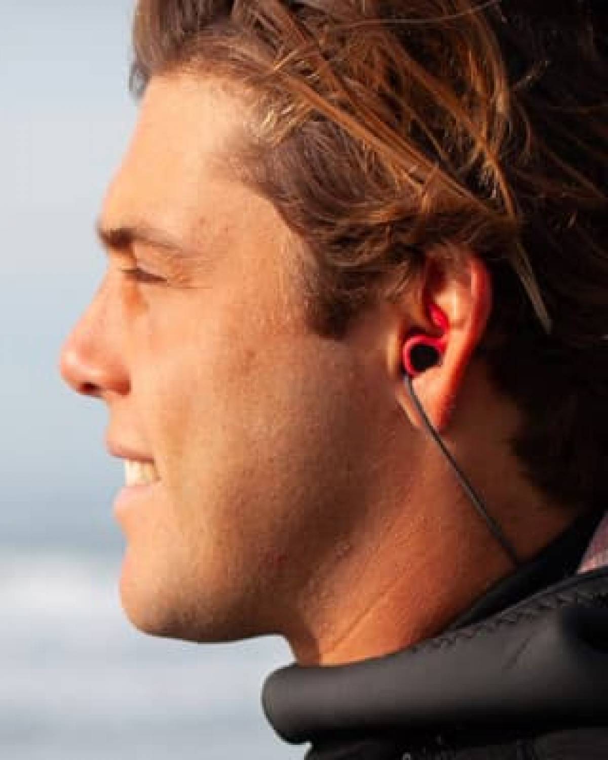 SurfEars 3.0 surf ear plugs worn by surfer