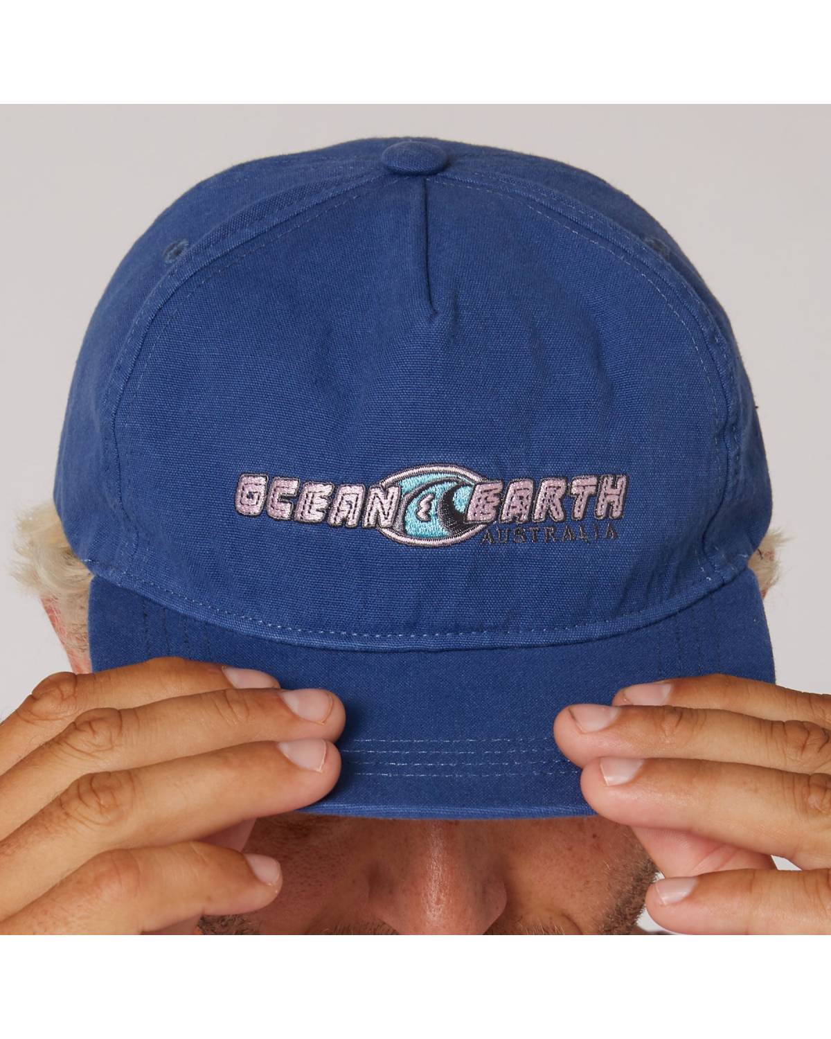 Close-up of Denim Blue cap logo