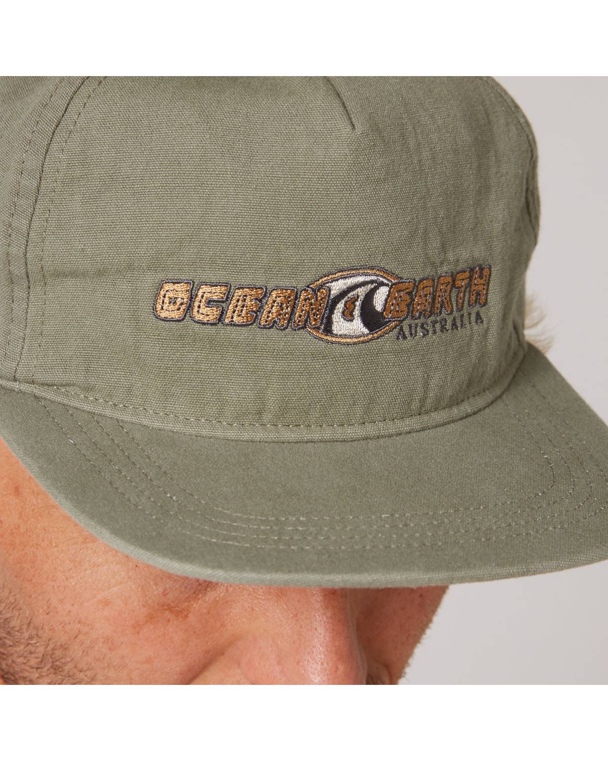 Close-up of Olive Nineties Wave Cap logo