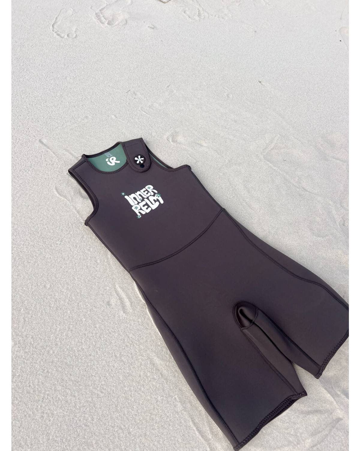 Green wetsuit beach view