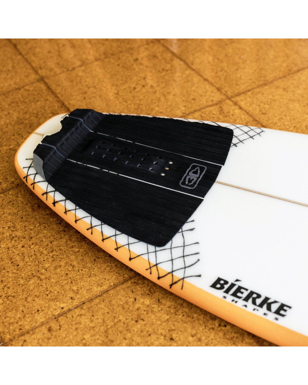 Tail pad on surfboard in water