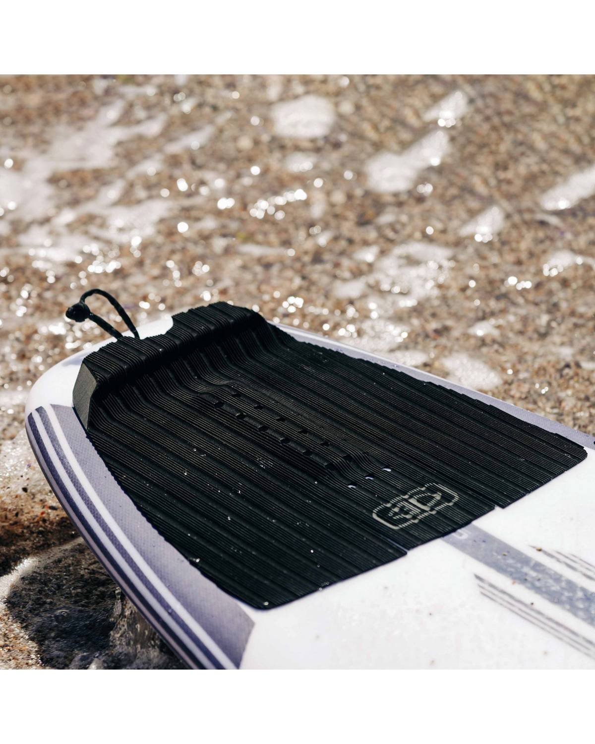 Tail pad on surfboard in water