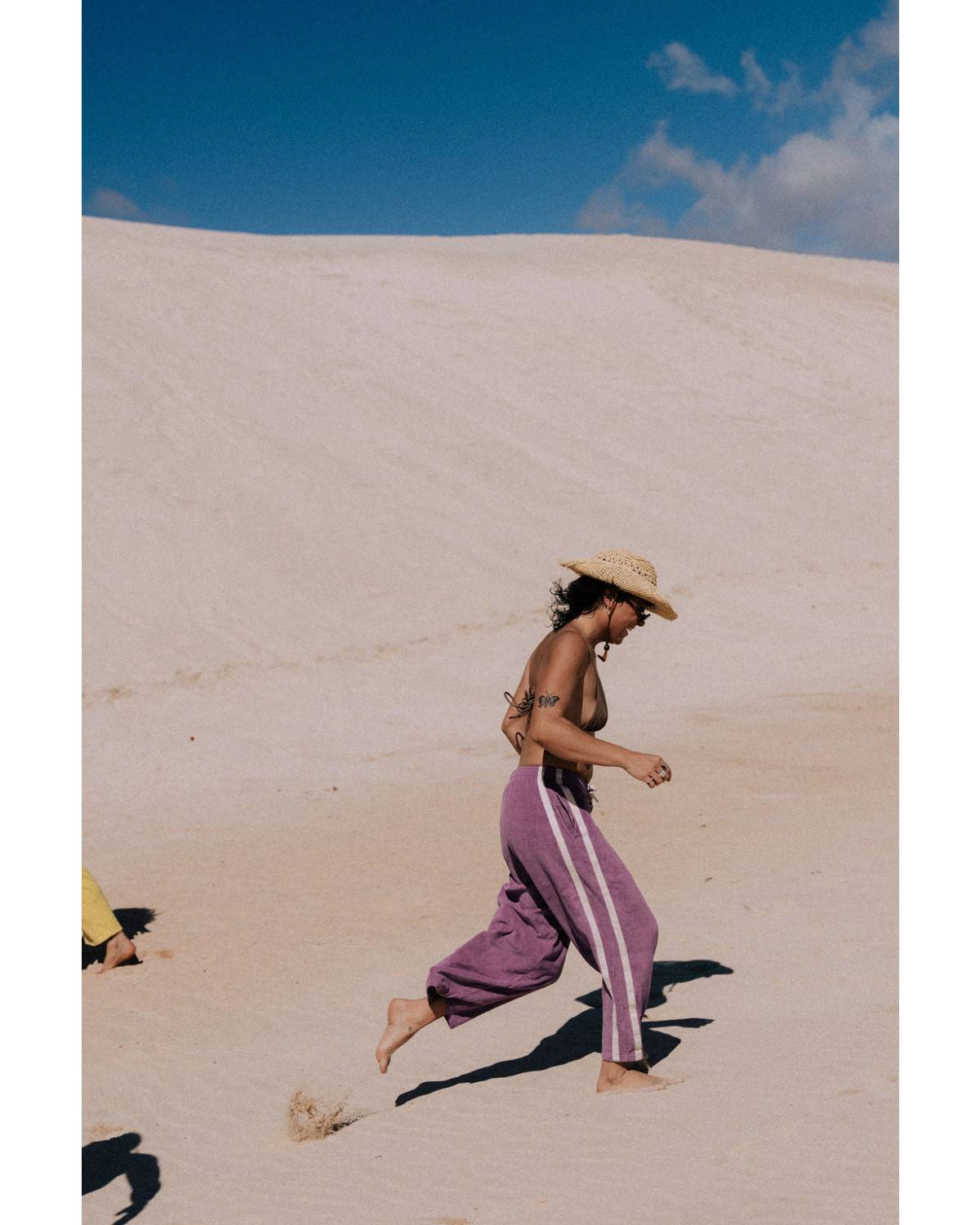 Model in purple pants on beach