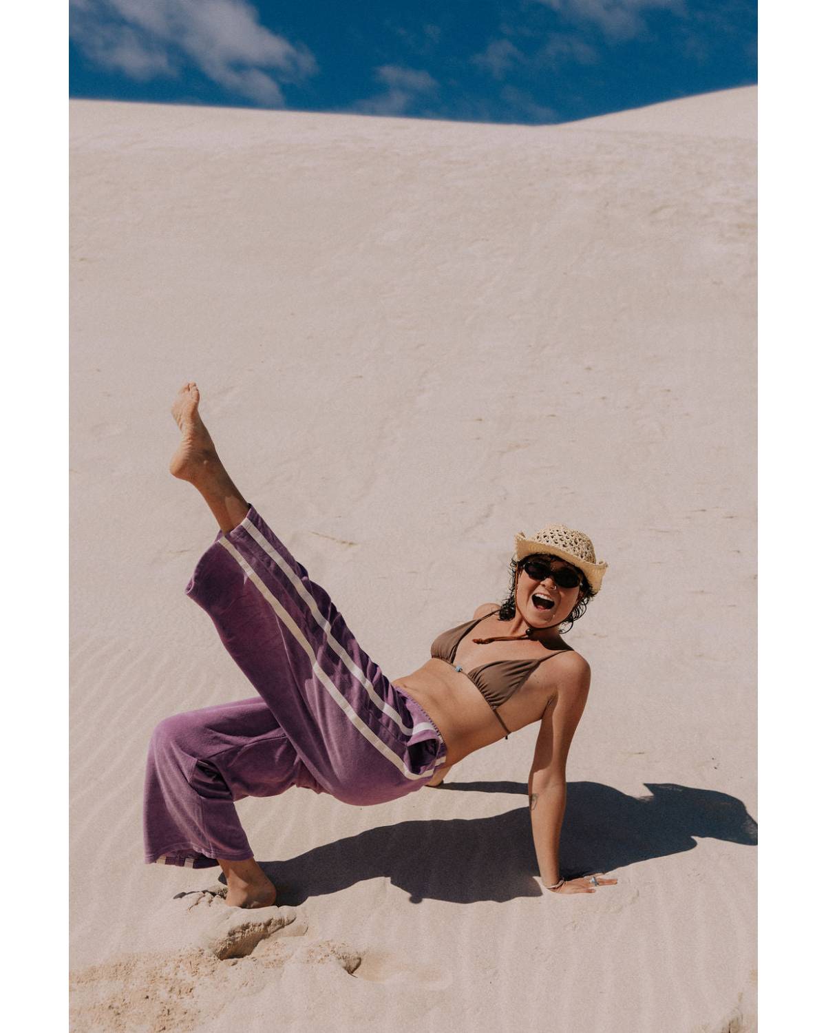 Model posing in purple pants