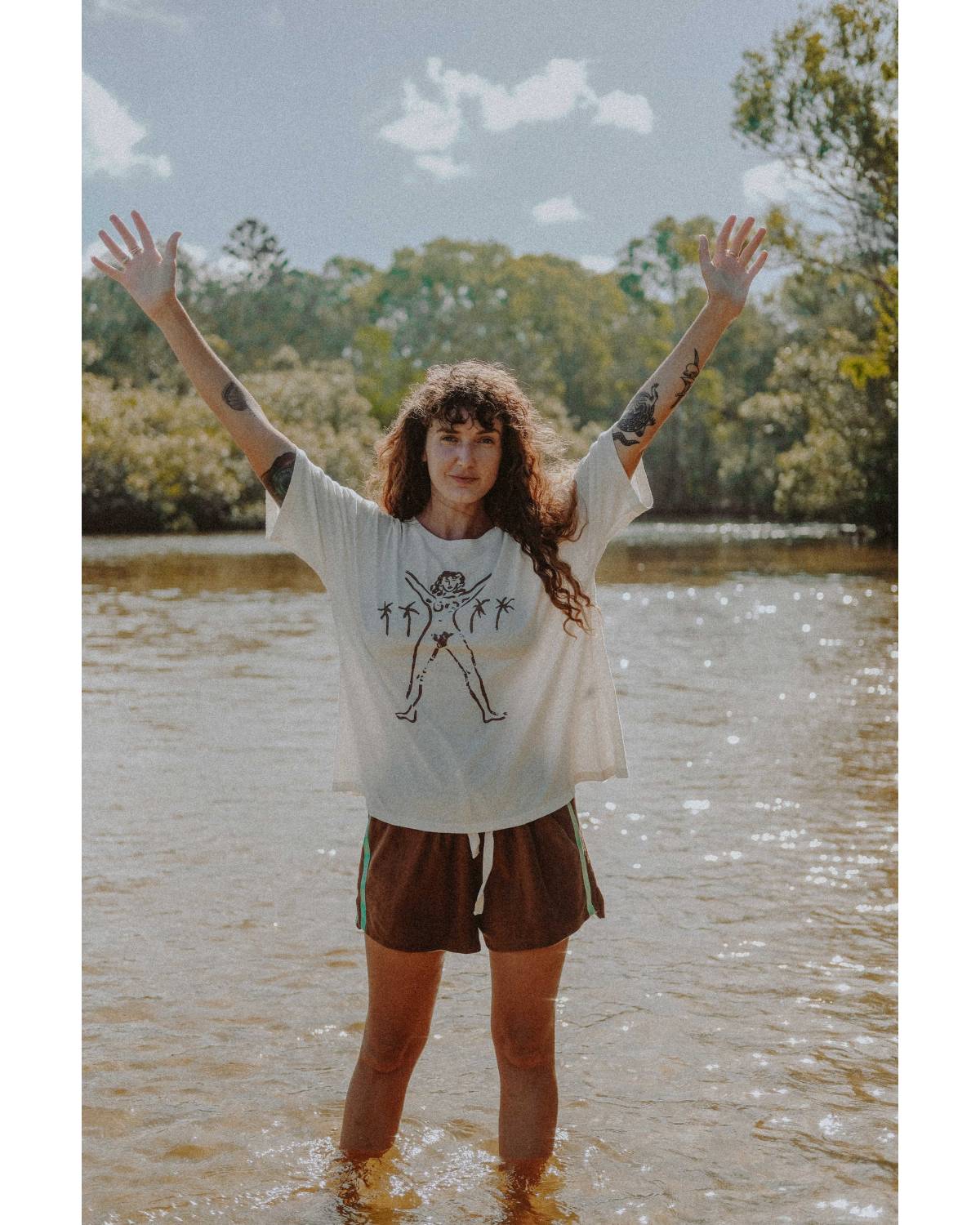 Model in Bush Woman Tee by water