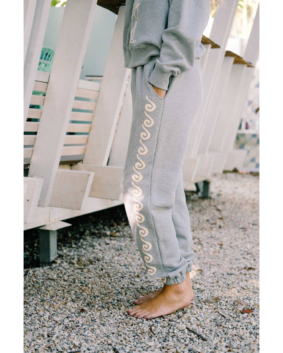 Model sitting in Bush Woman Track Pant