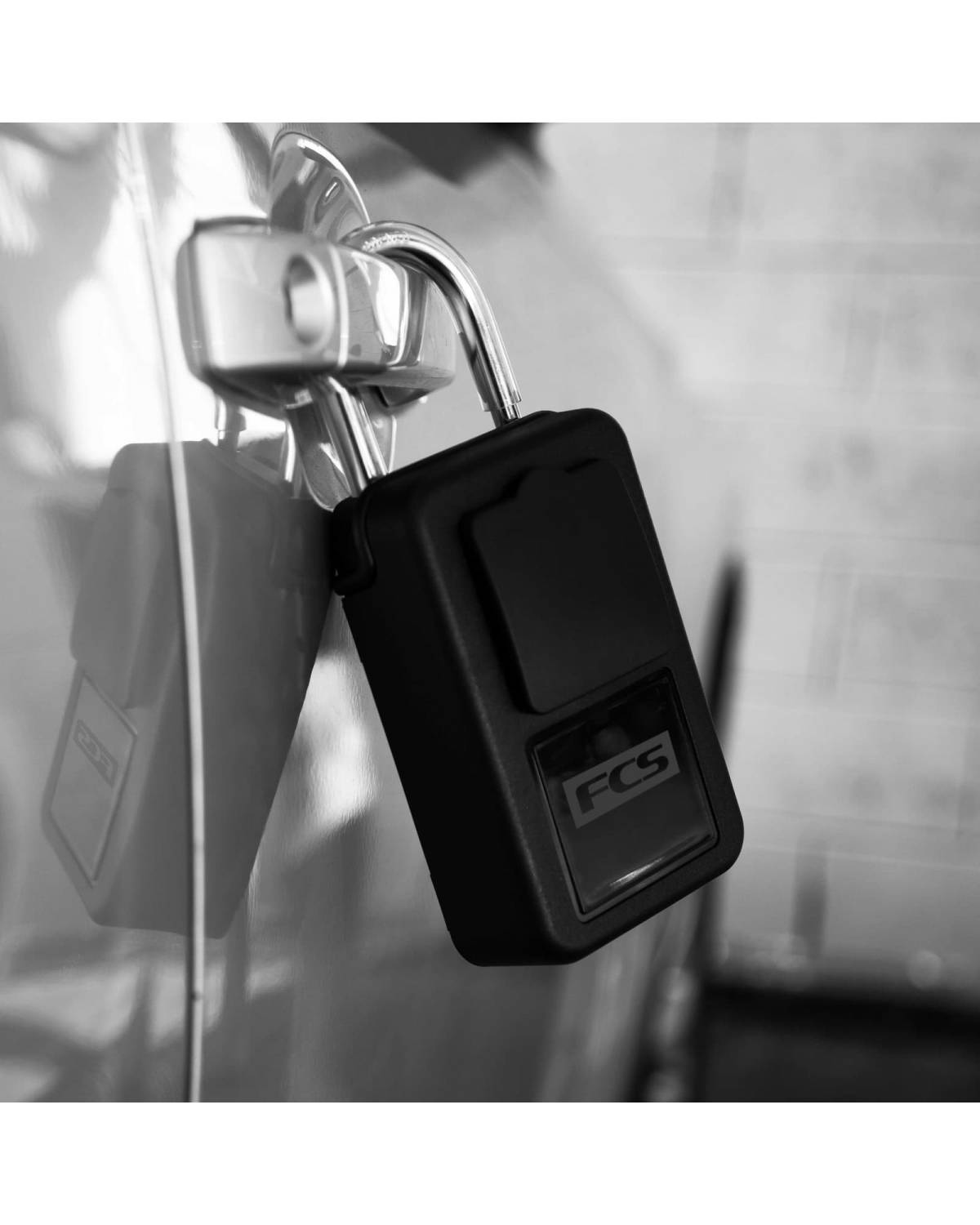 FCS KEY LOCK - BLACK attached to a car door handle