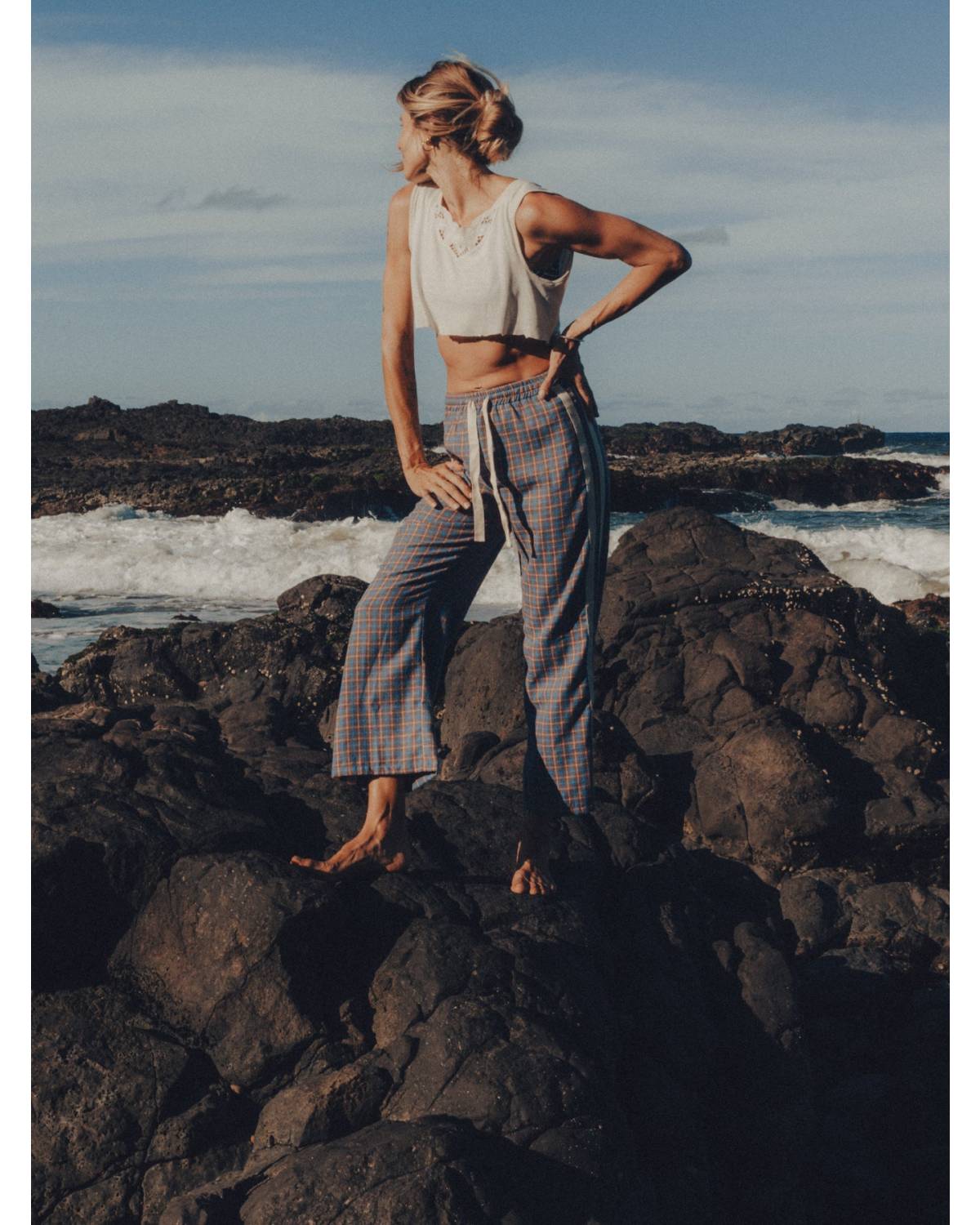 Flannel pants on rocks by sea