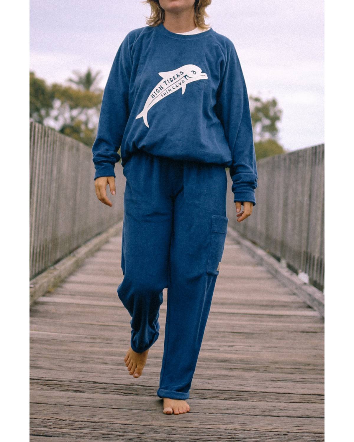 Sweater walking on bridge