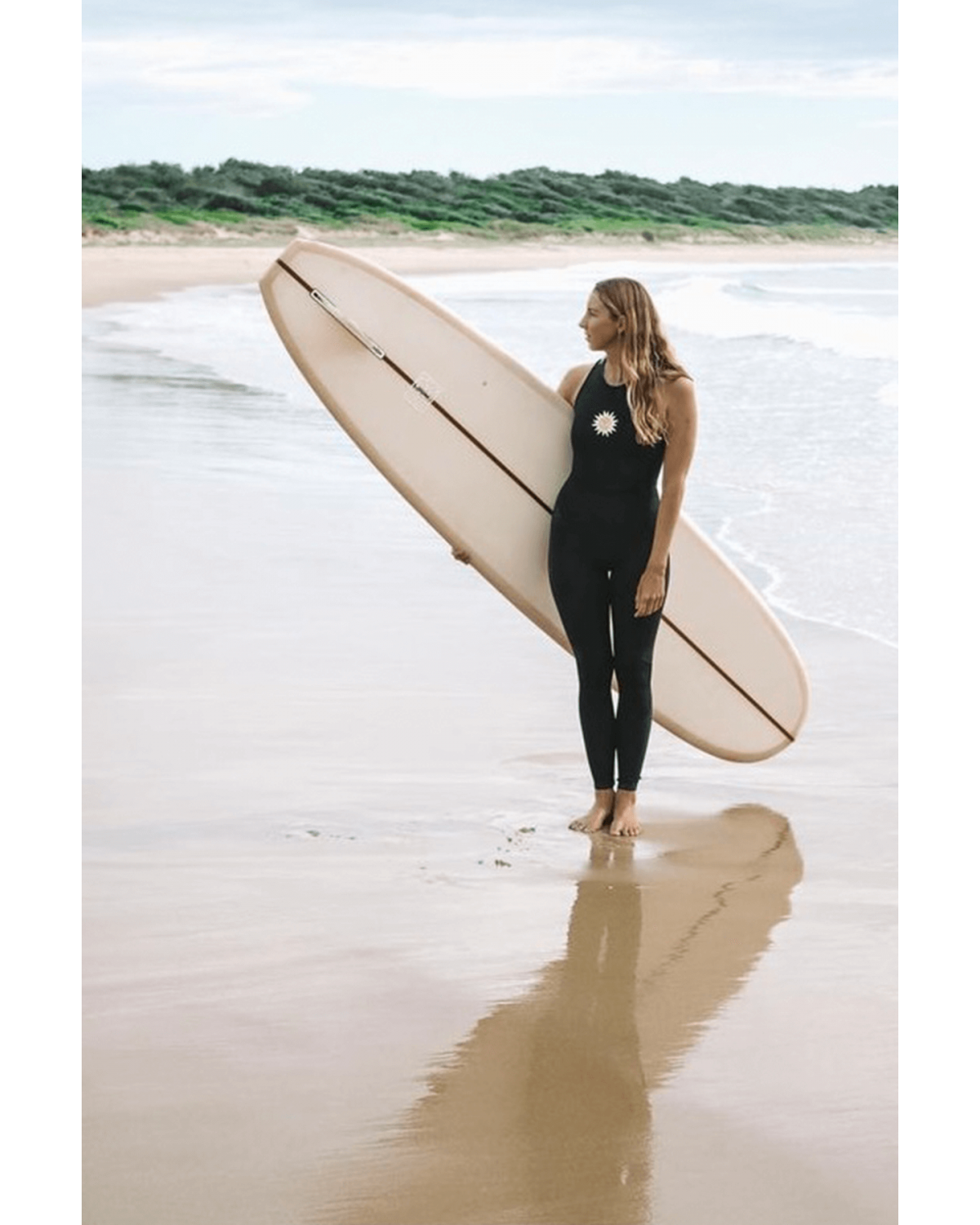 Inner Relm Happyheart Long Jane on model with surfboard