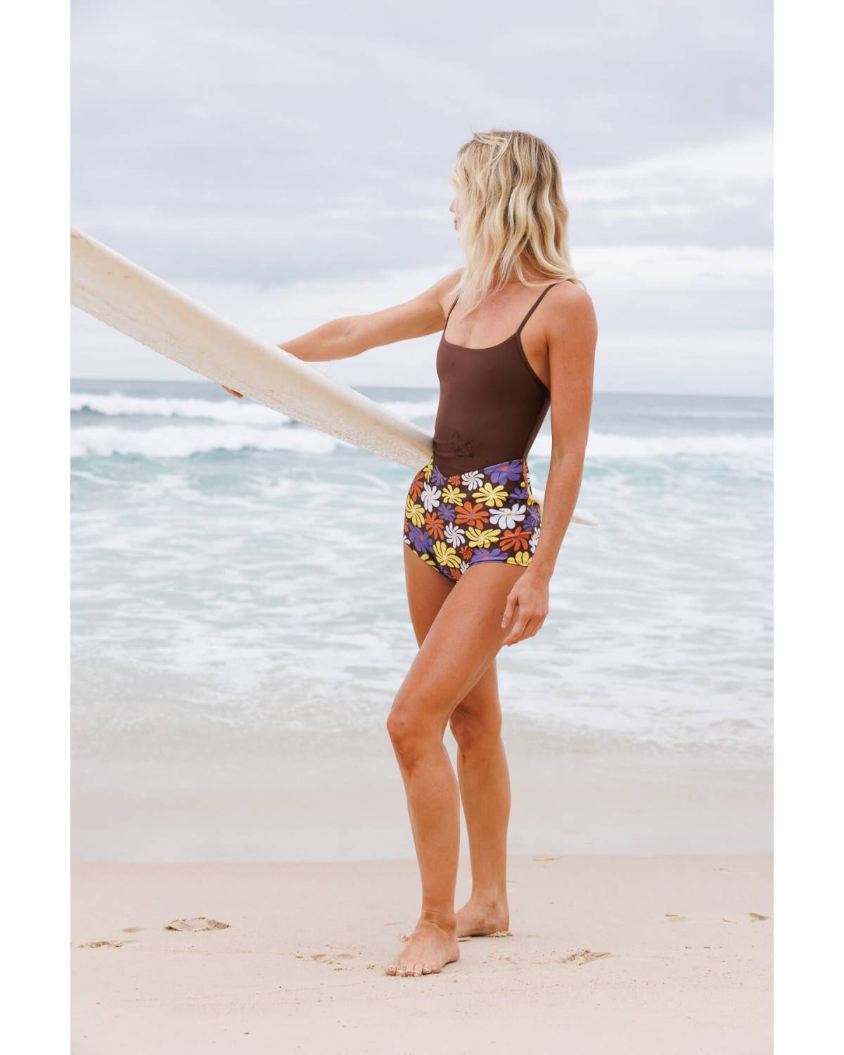 Model posing on rocky beach
