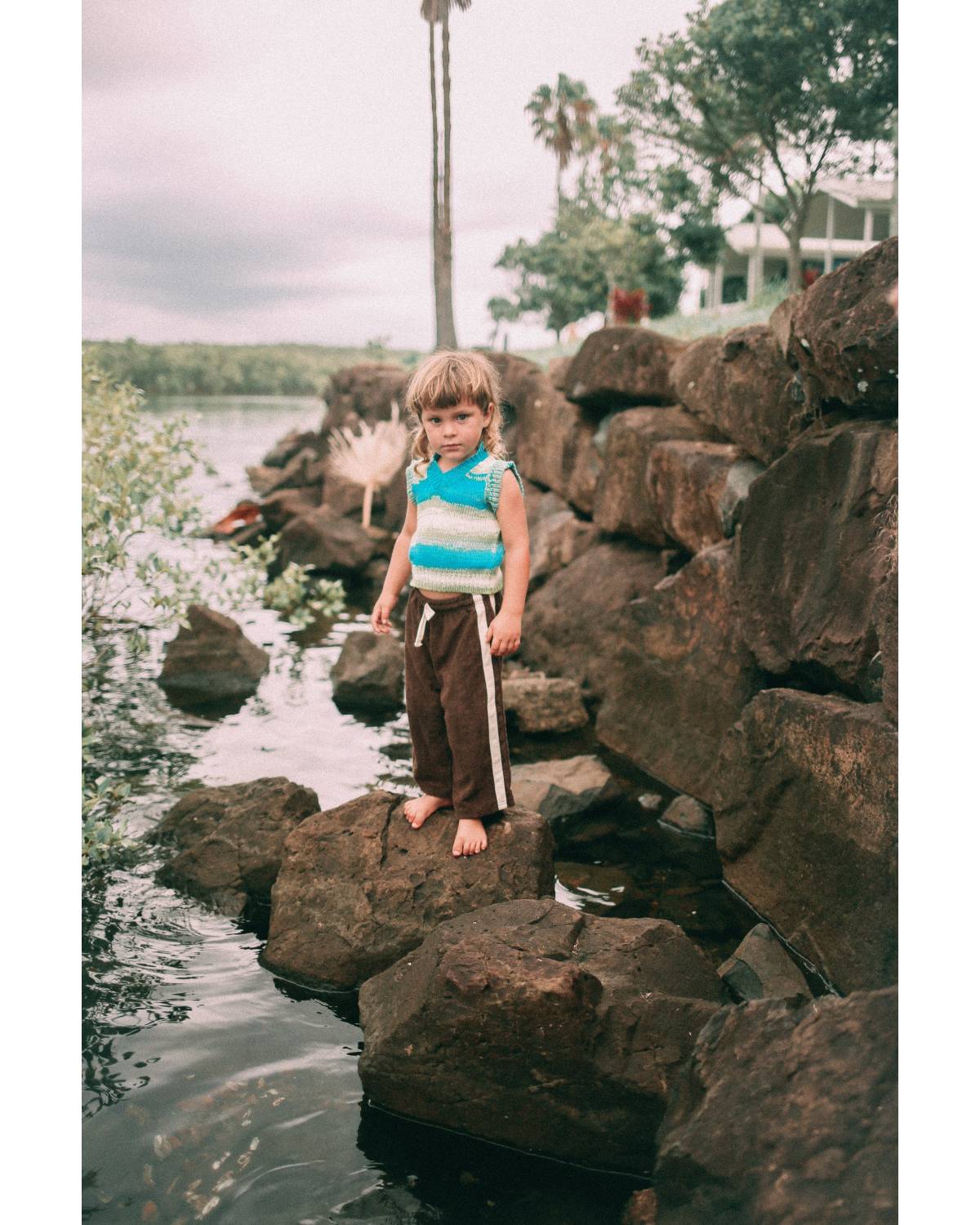Child and adult on rocks