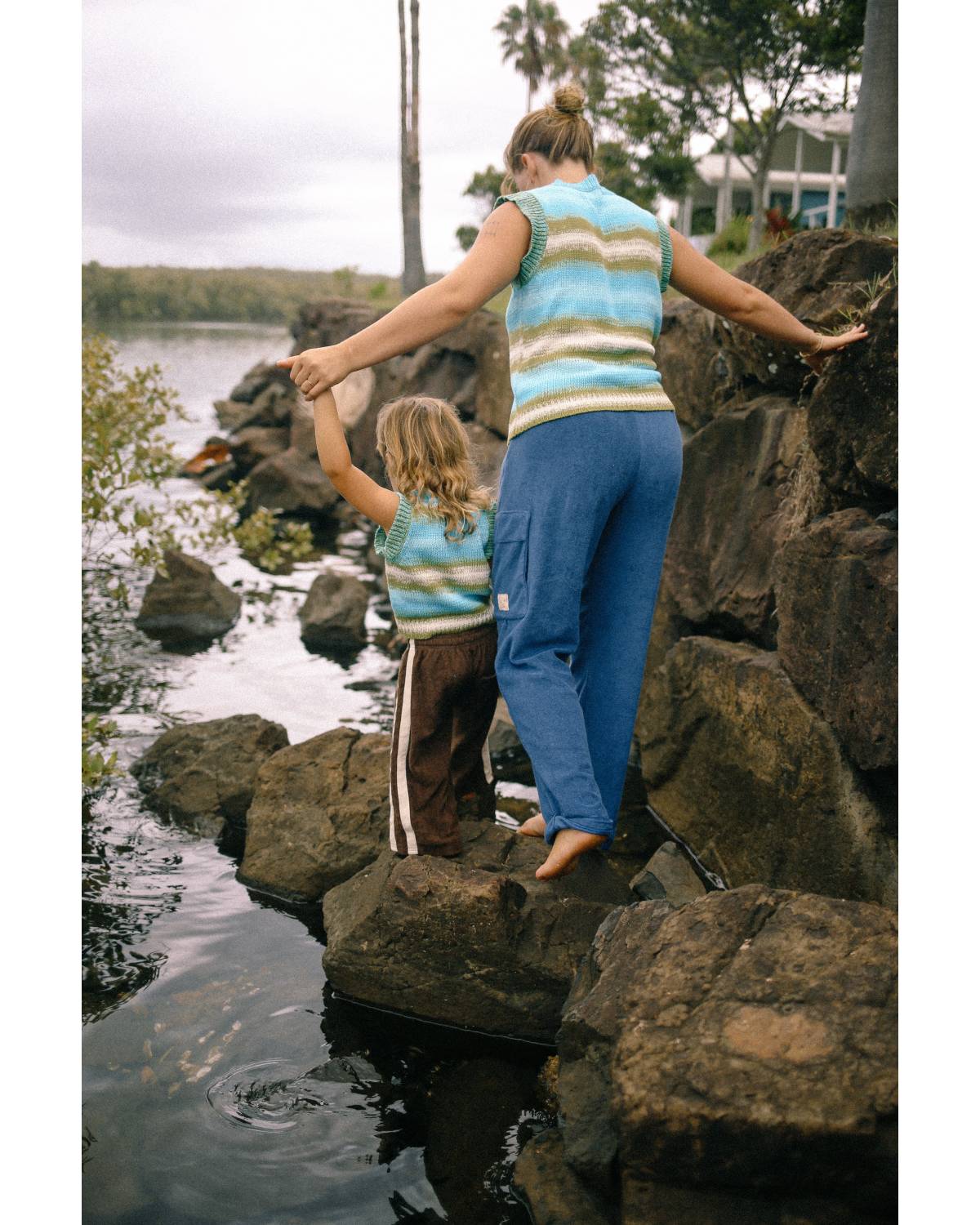 Child in vest by water
