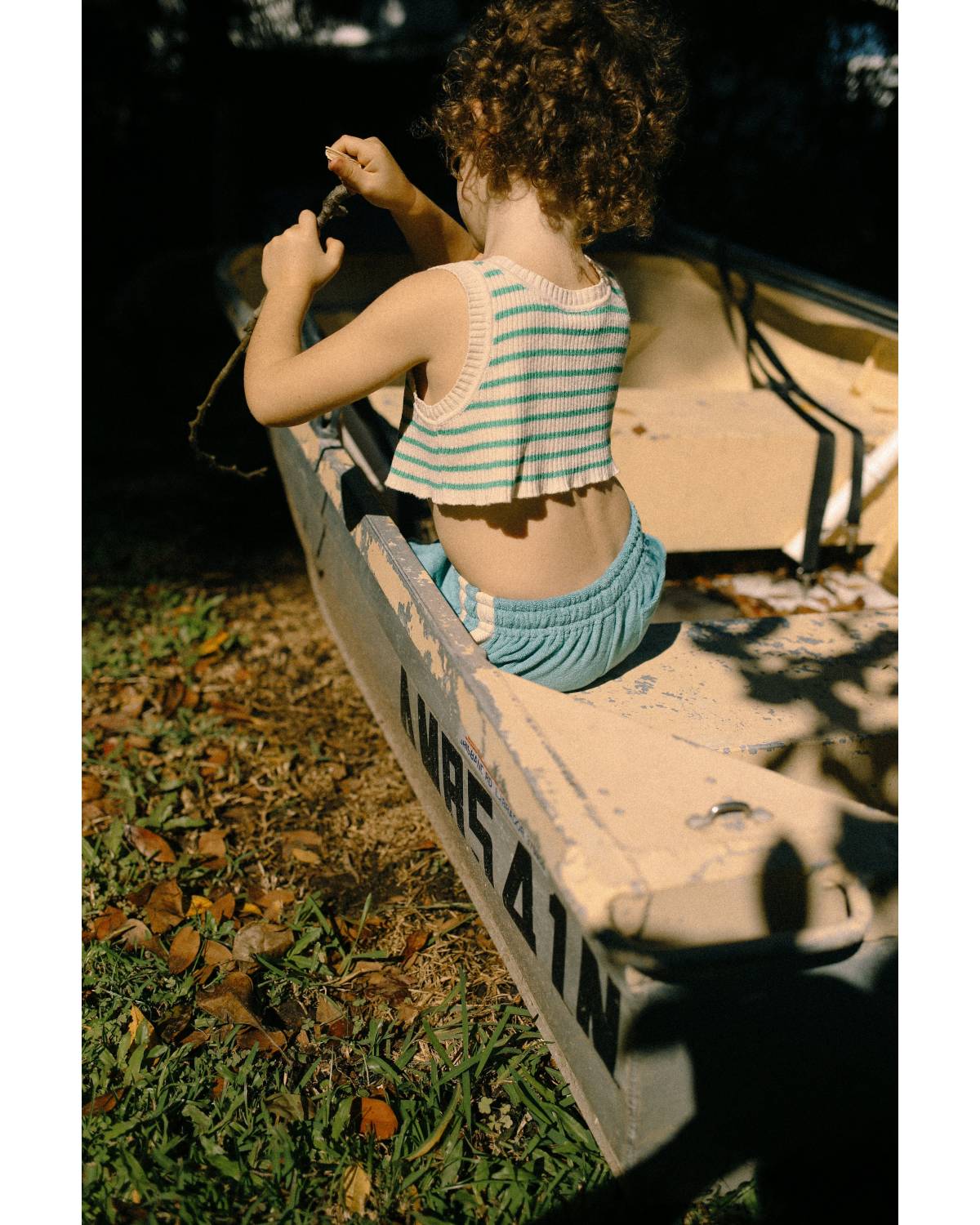 Child in boat with striped top