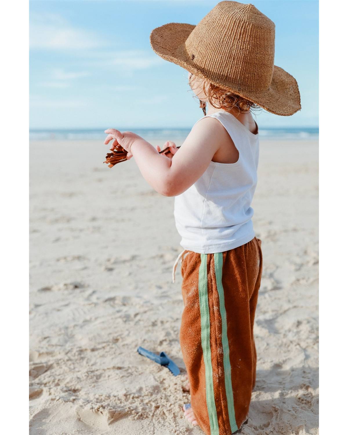 Side view with hat on beach