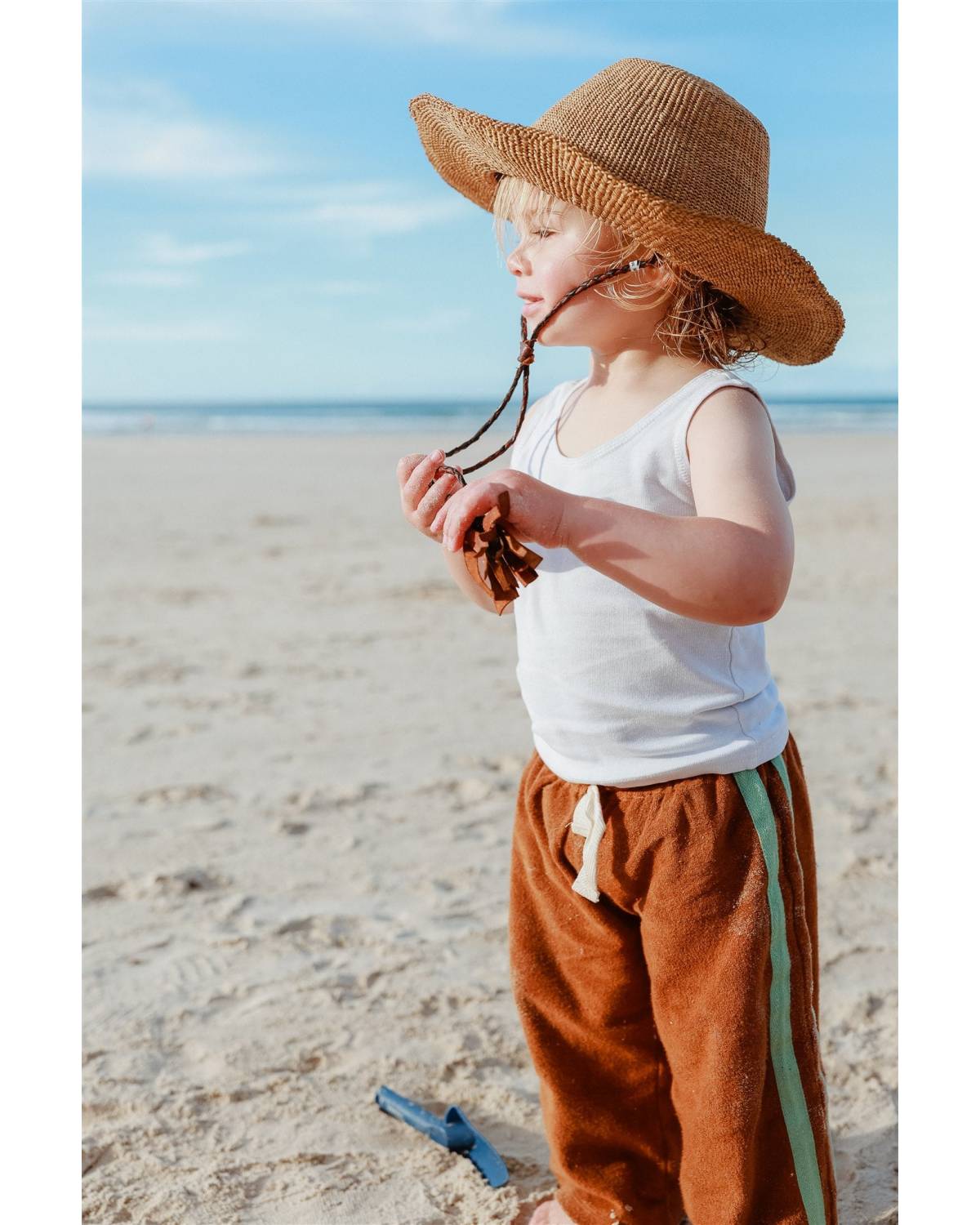 Child with hat looking down