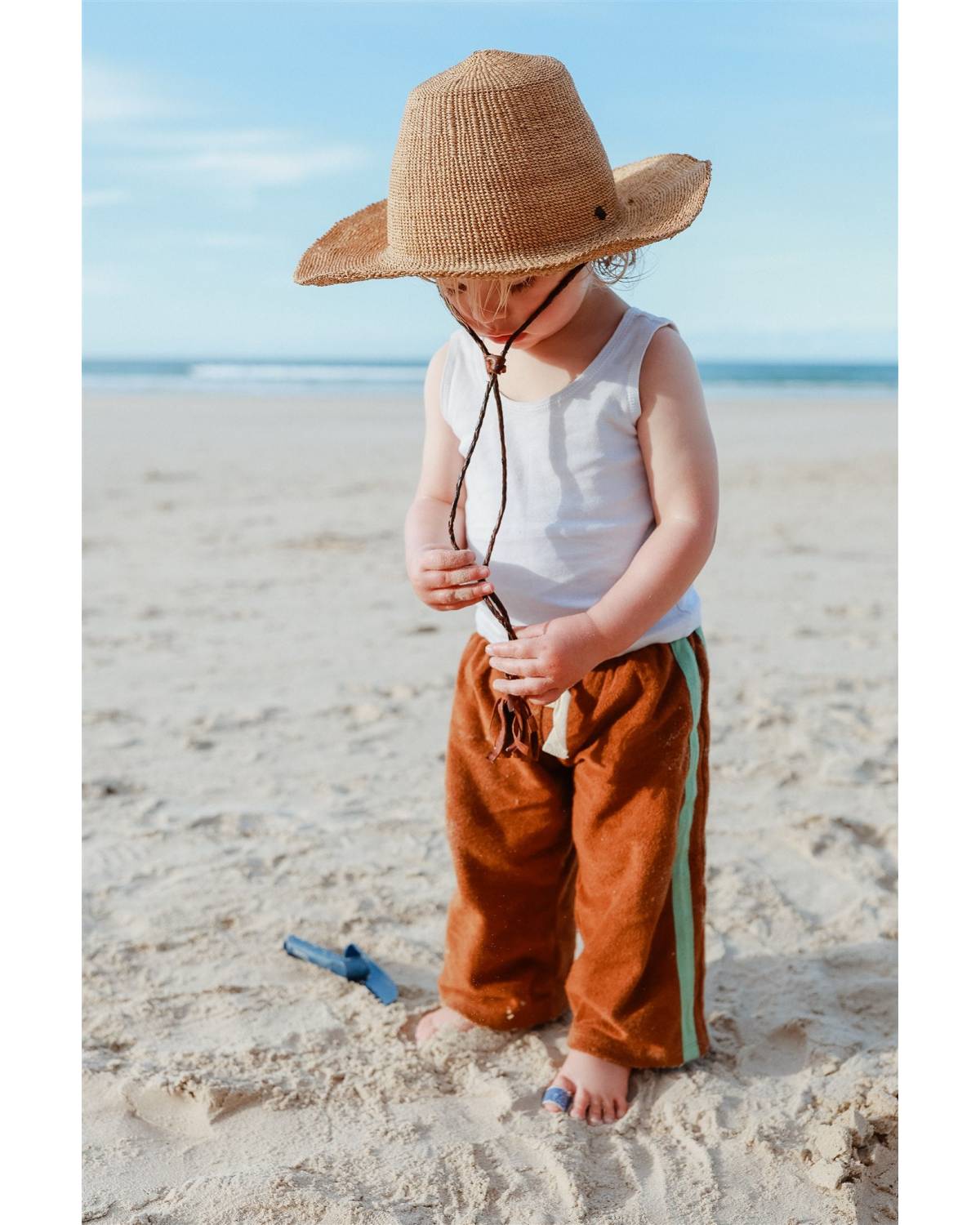 Back view with hat on beach
