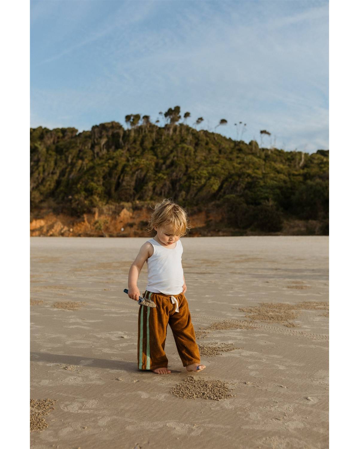 Child with hat on beach