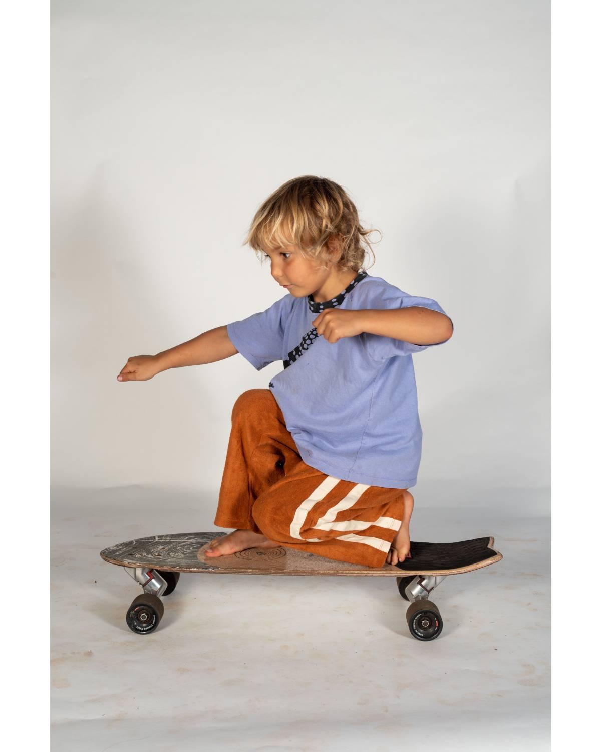 Child on skateboard side view