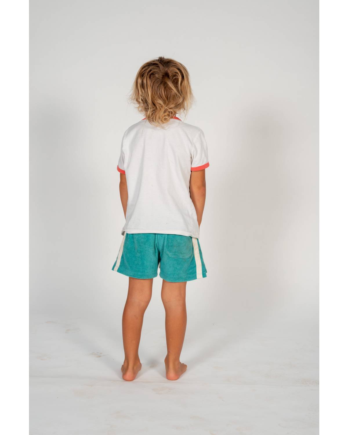 Child on skateboard crouching