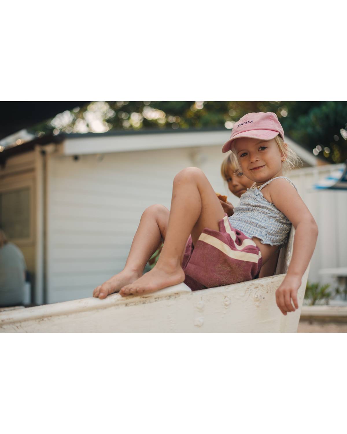 Child sitting on boat smiling