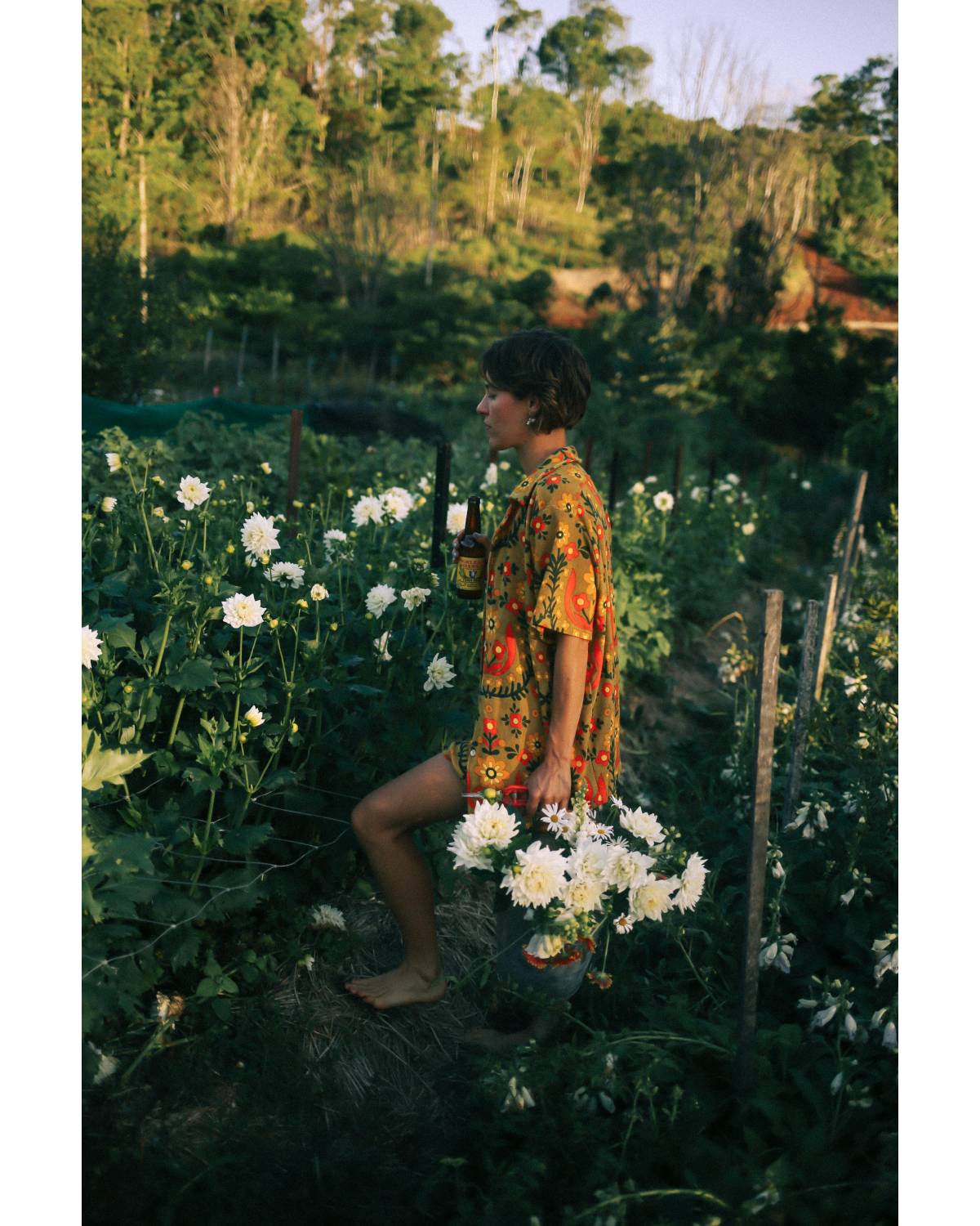 Shirt in garden holding flower