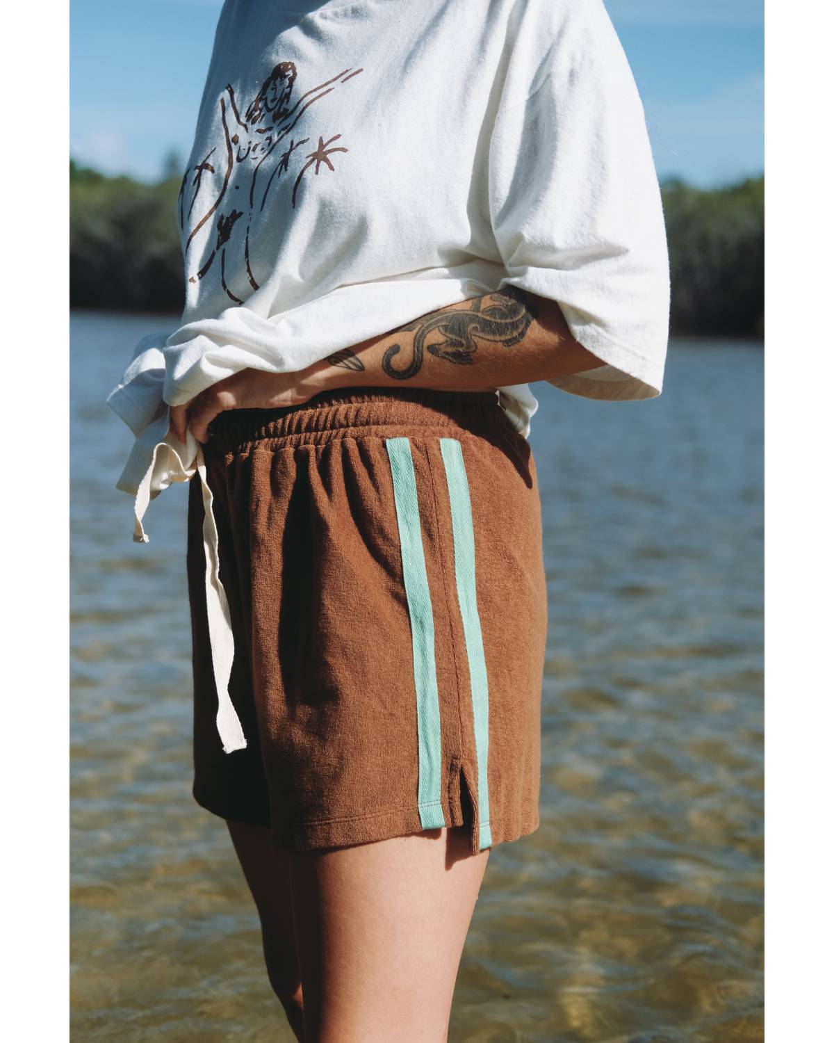 Model wearing shorts with white top