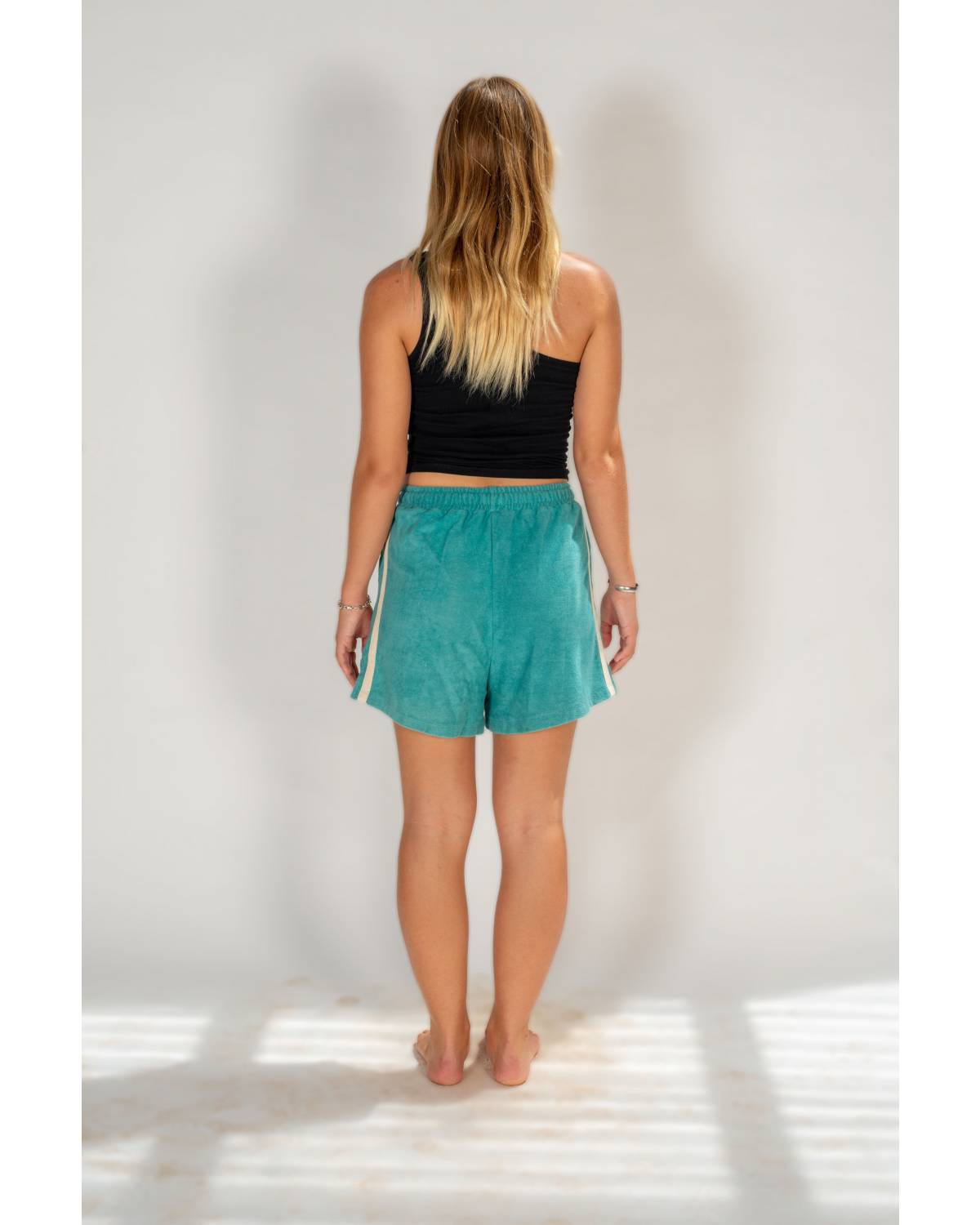 Model sitting in shorts