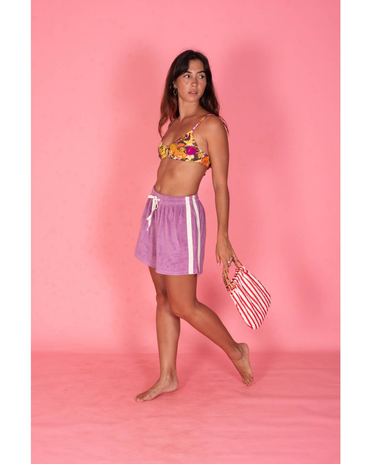 Model holding bag on pink