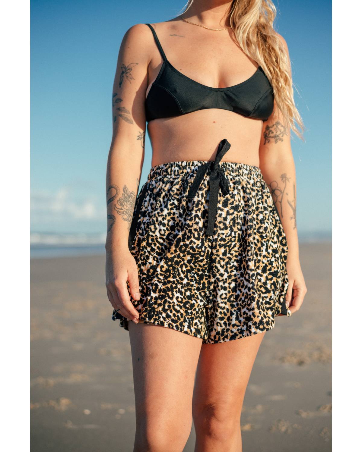 Model with surfboard and shorts