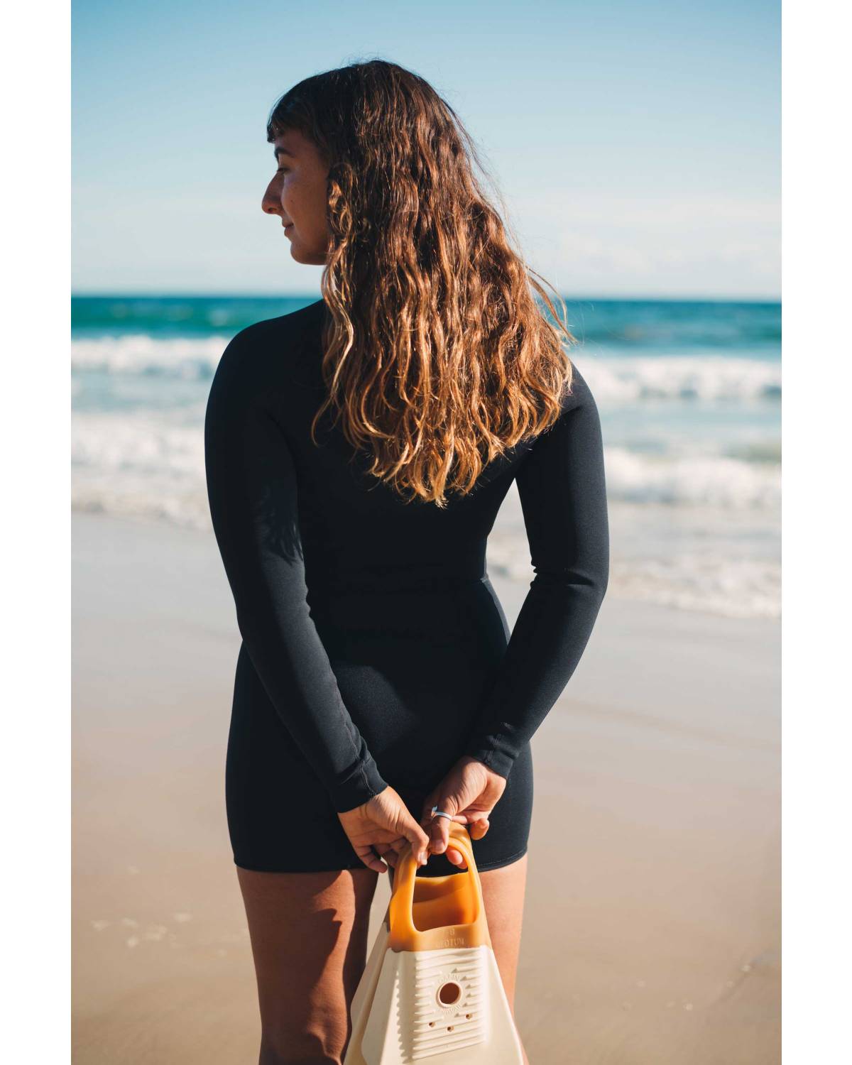 Wetsuit on beach shading eyes