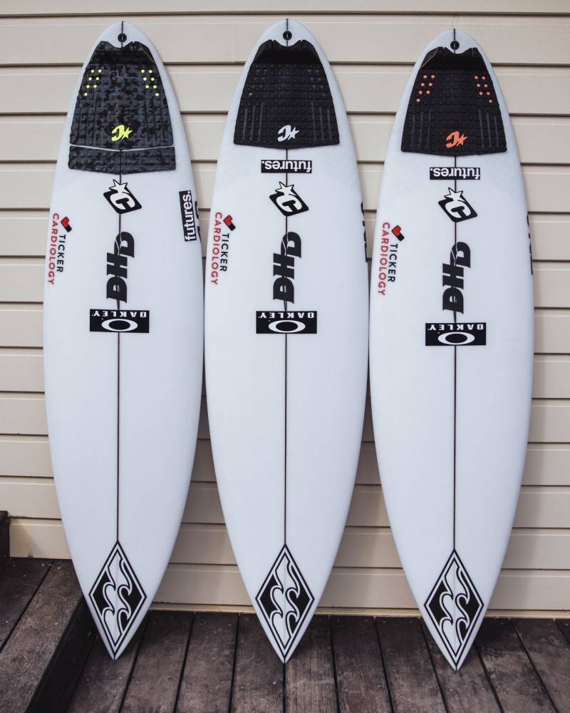 Three surfboards with traction pads