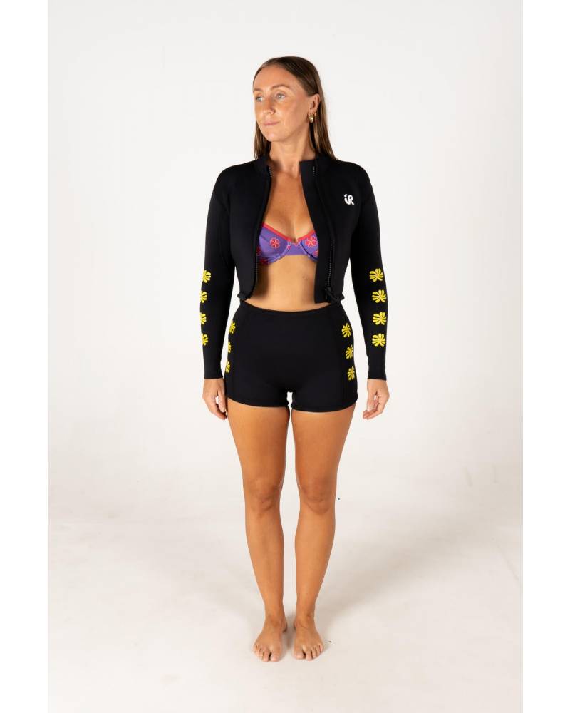 Model with surfboard in Black Betty Vest