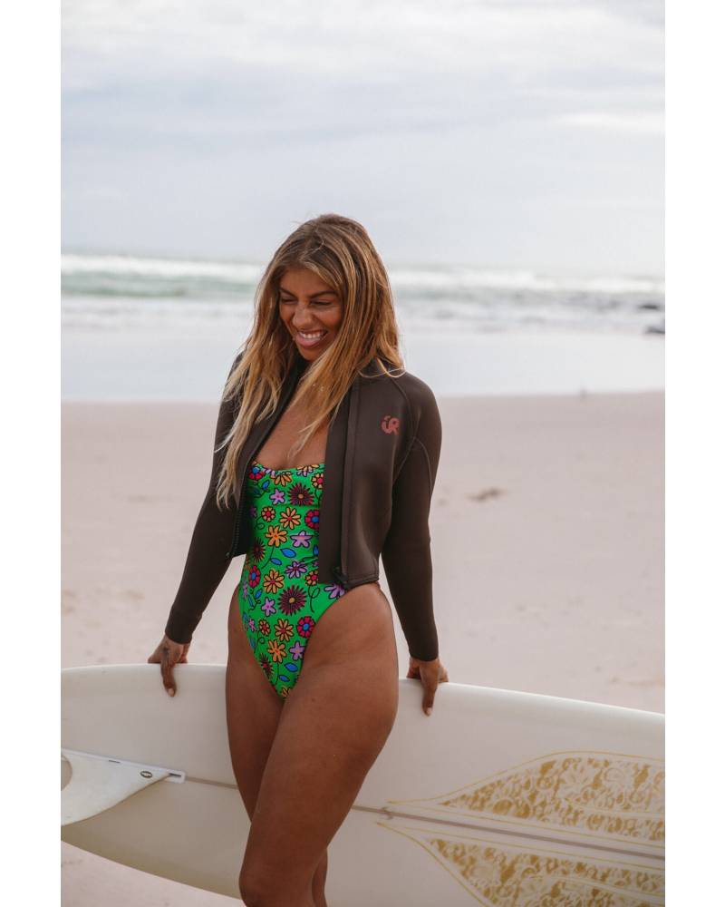 Model smiling with surfboard