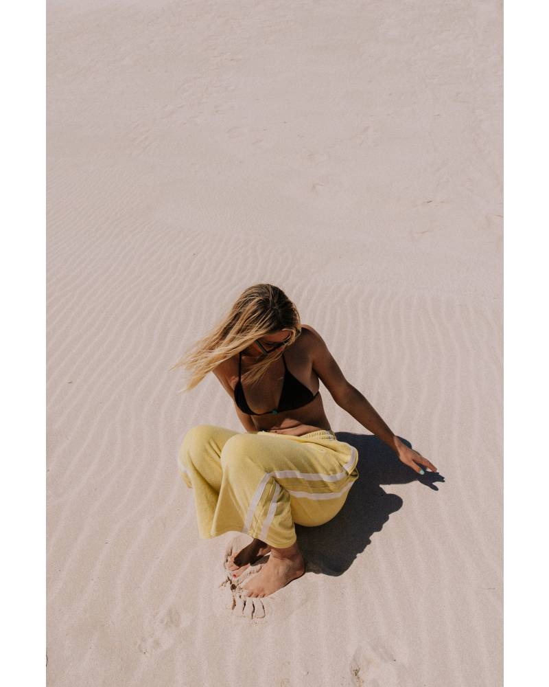 Model sitting in yellow pants