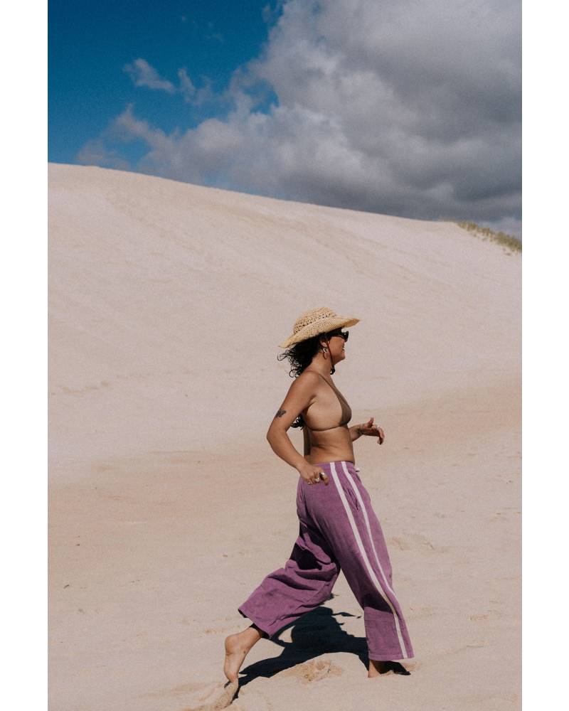Purple pants on sand