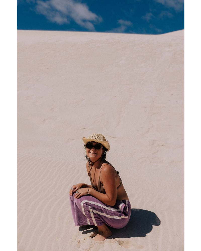 Model walking in purple pants