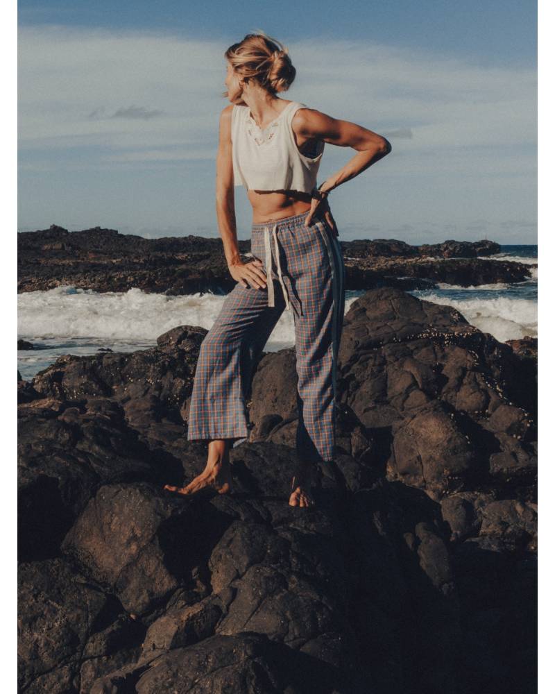 Flannel pants on rocks by sea