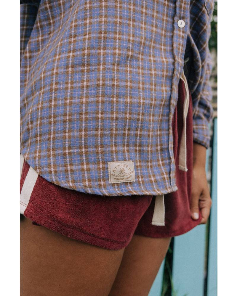 Model in flannel shirt by station