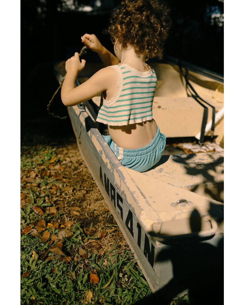 Child in boat with striped top