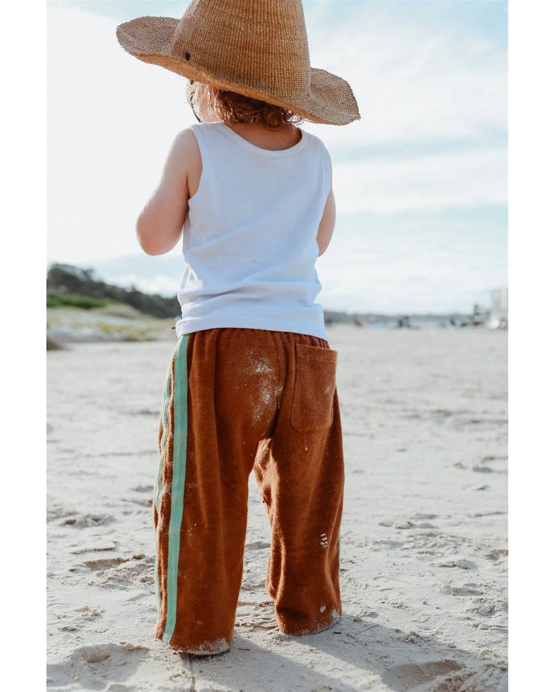 Child with hat on beach