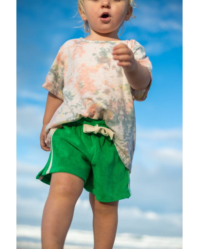 Green shorts on beach