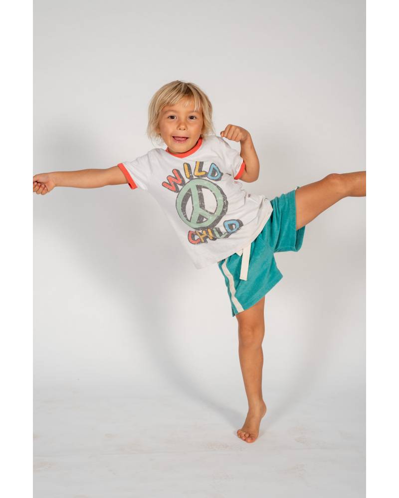 Child in shorts on white background
