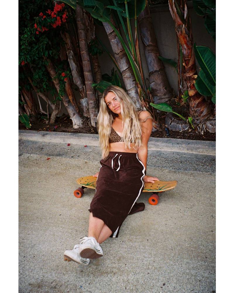 Skirt with skateboard standing