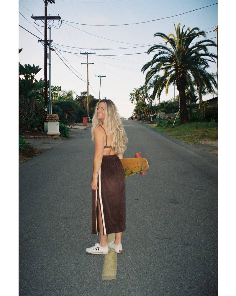 Skirt with skateboard on road