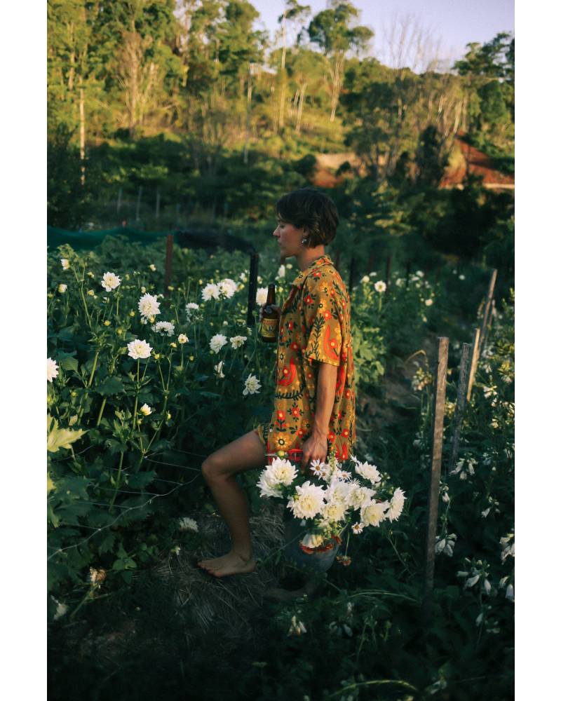 Shirt in garden holding flower