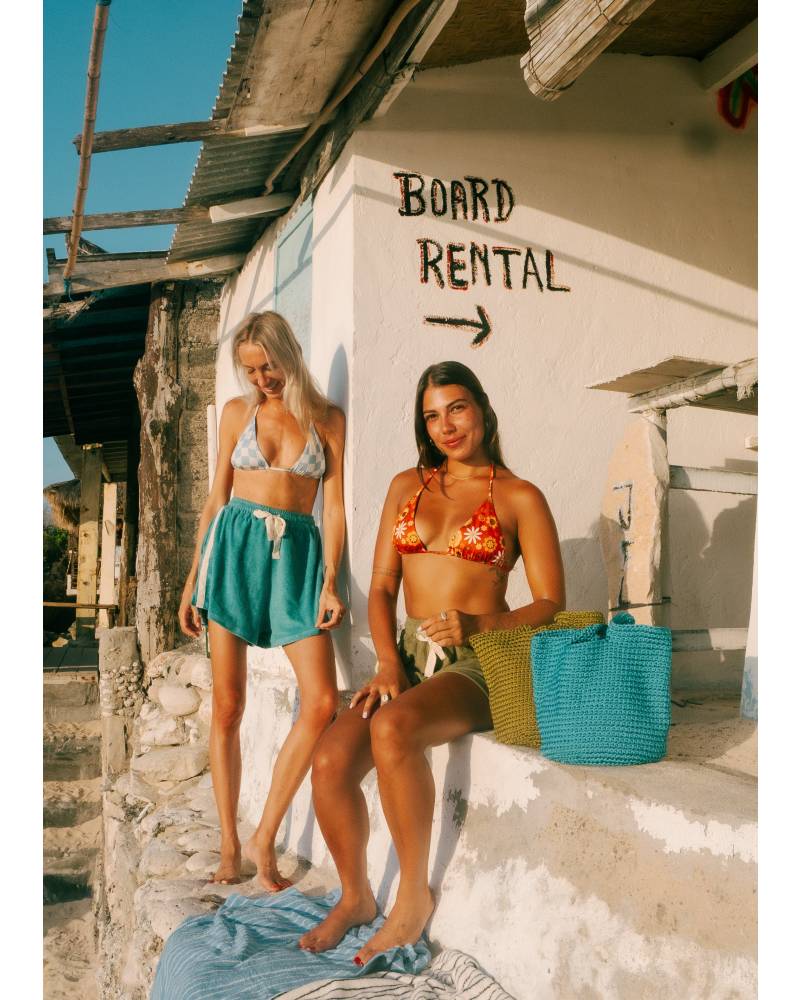 Model wearing shorts at beach