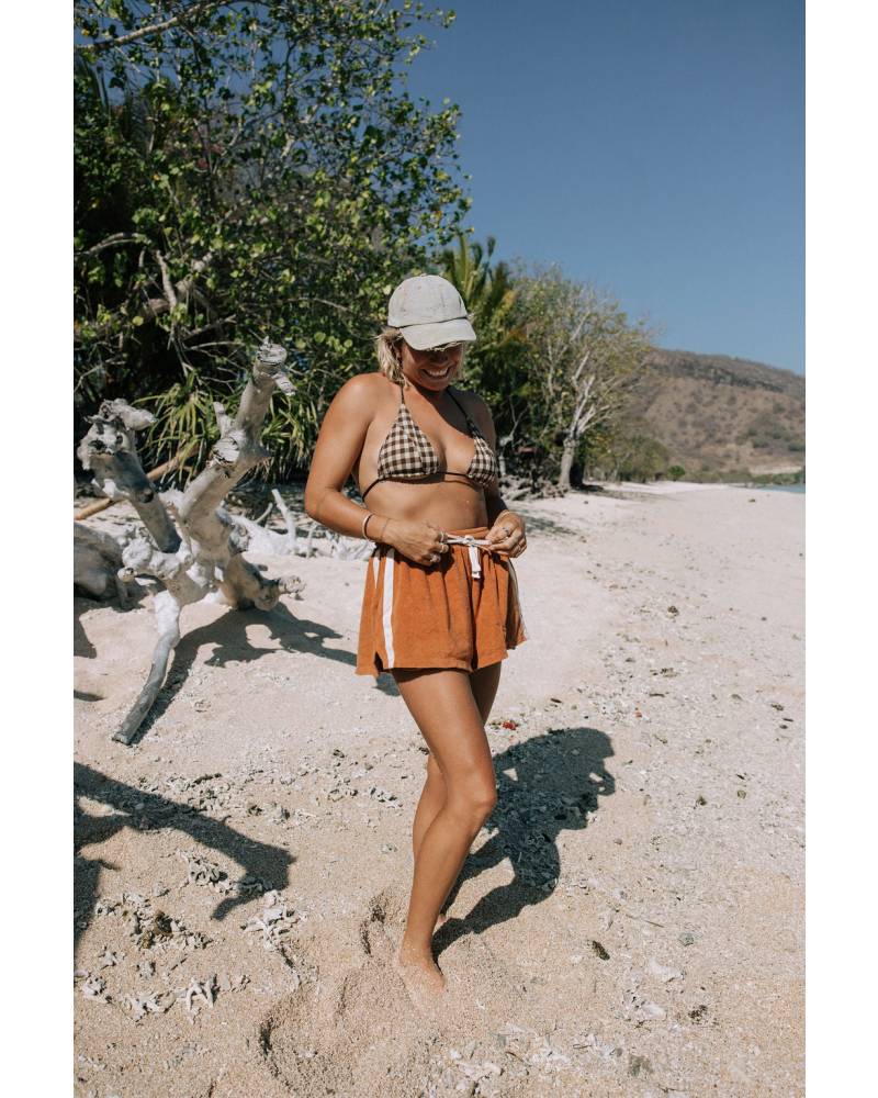 Model sitting on driftwood