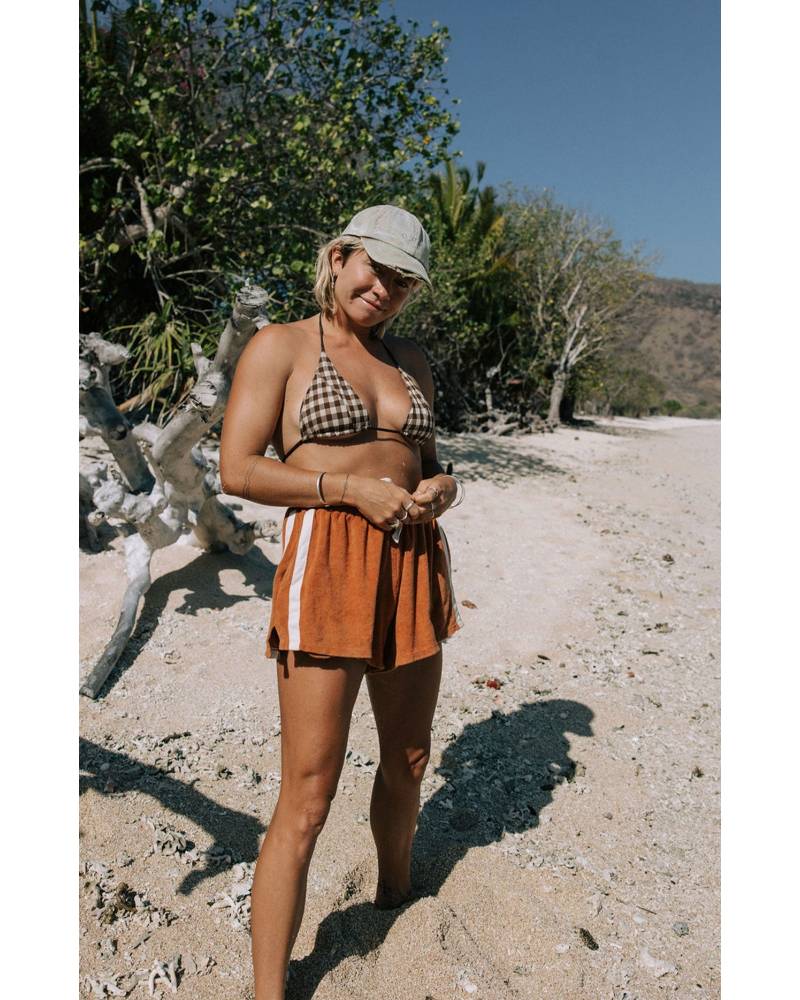 Model wearing shorts on beach