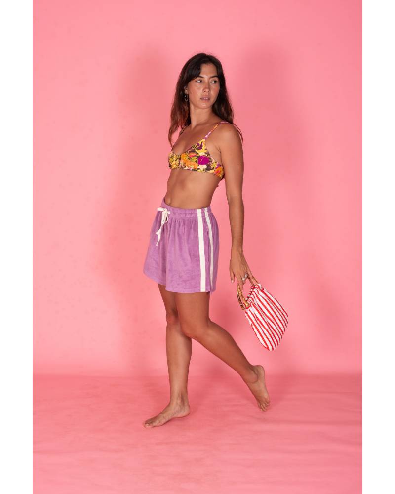 Model holding bag on pink